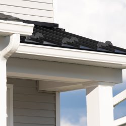 New rain gutter on a home against blue sky New rain gutter on a home against blue sky rain facade white